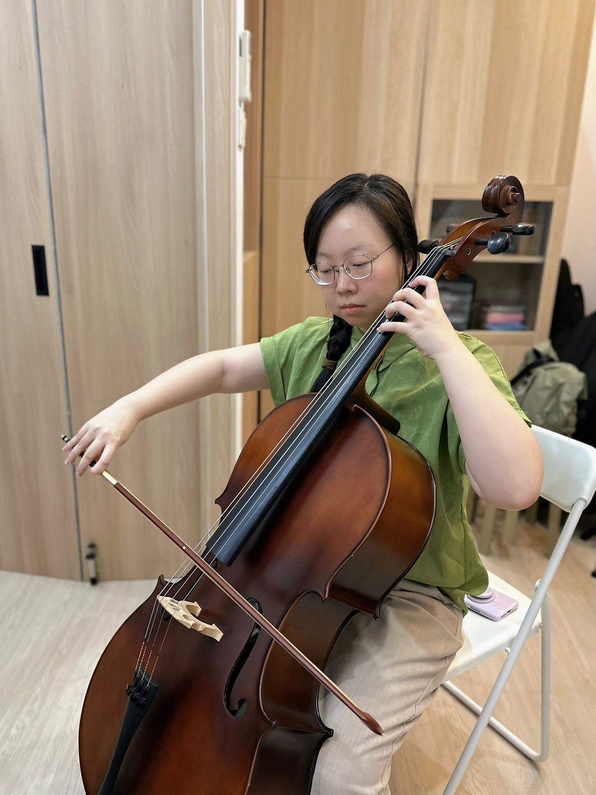 An adult cello student in a lesson at Bowed Strings Music Studio